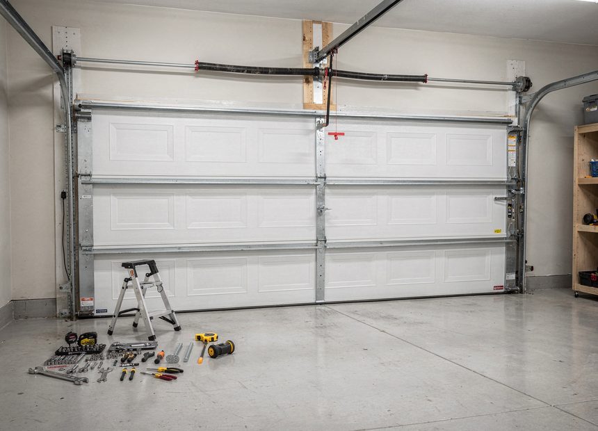 Garage door tracks, spring, and repair tools in a Montgomery, AL garage